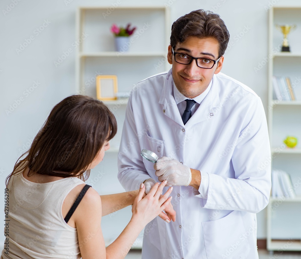 Fototapeta premium Doctor examining the skin of female patient