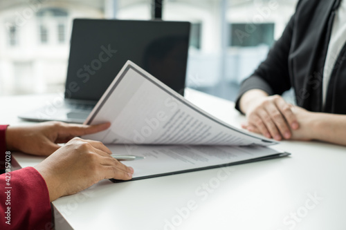 Business people hold a resume and talk to job applicants for job interviews about careers and Their personal history in the company. Recruitment concepts