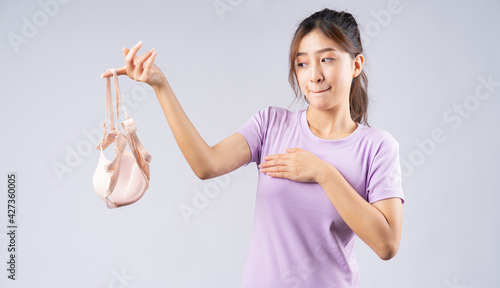 Canvas-taulu The young Asian girl took off her bra with a happy face