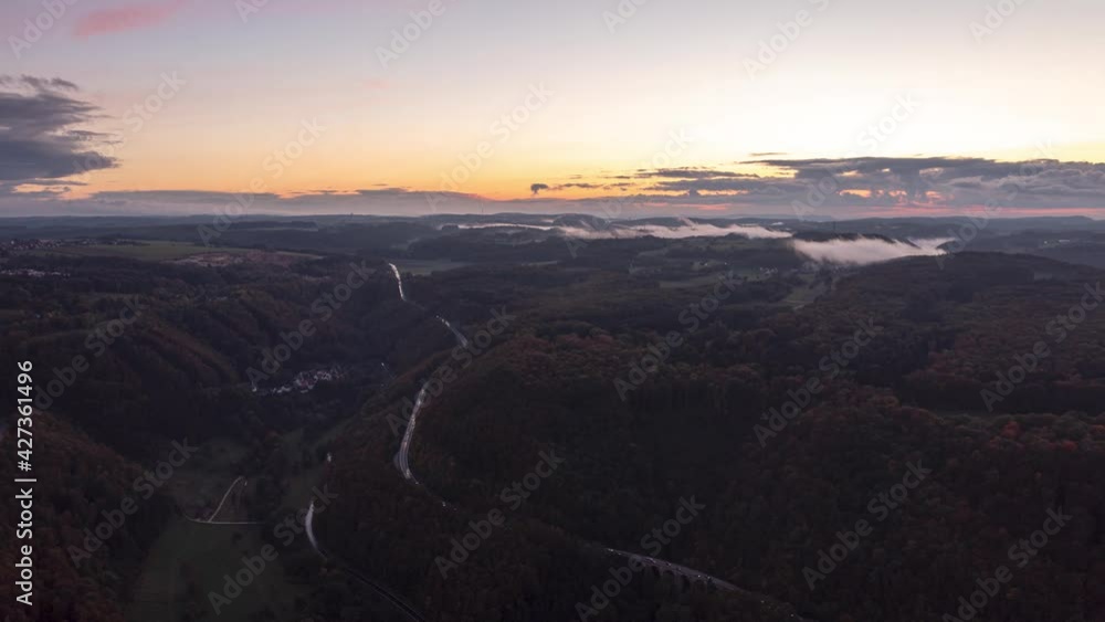 Time lapse or hyper lapswith a drone in sunset with fog on above a freeway in the district of göppingen Time lapse or hyper lapswith a drone in sunset with fog on above a freeway in the district of göppingen