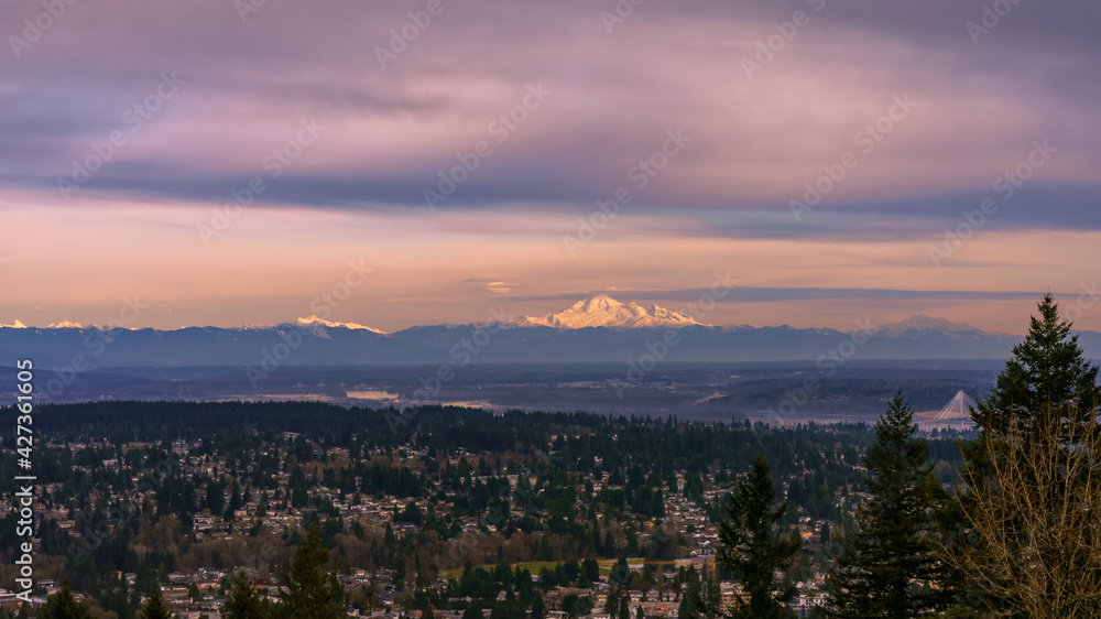 Dusk view across valley to roseate alpine mountain