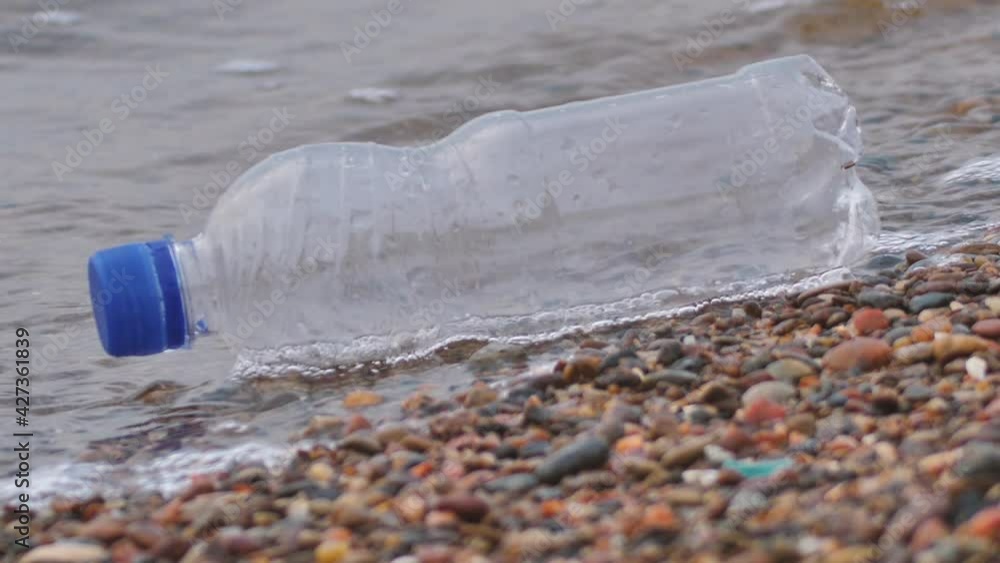 Plastic bottle by the sea. Plastic as waste. Environmental pollution problem concept Plastic bottle by the sea. Plastic as waste. Environmental pollution problem concept