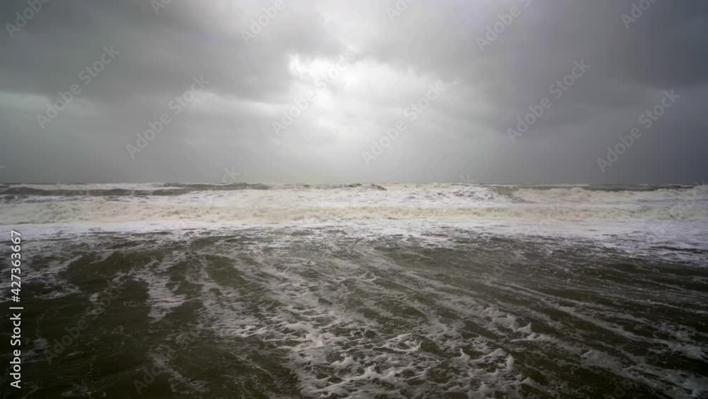 Stormy weather and with huge sea waves breaking on seashore and Neptune statue. Pan right Stormy weather and with huge sea waves breaking on seashore and Neptune statue. Pan right