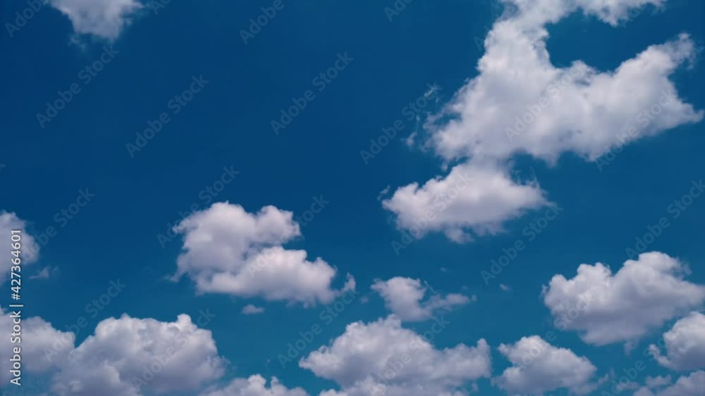 Time lapse, motion fluffy of groups white clouds moving on blue sky background