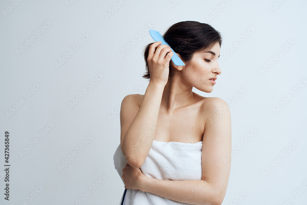 Pretty brunette combs hair bare shoulders shower grooming Pretty brunette combs hair bare shoulders shower grooming