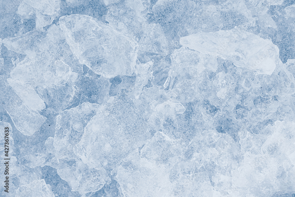 Obraz premium Ice pieces texture light background. Crushed ice blue-toned pattern.