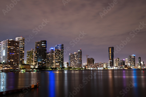 Miami Florida, sunset panorama with colorful illuminated business and residential buildings and bridge on Biscayne Bay. Miami night. © Volodymyr