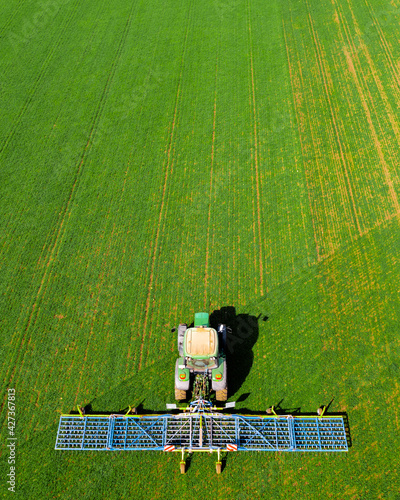  Tractor cultivating field at spring Amazing aerial view about this work. The farmer working agriculture 