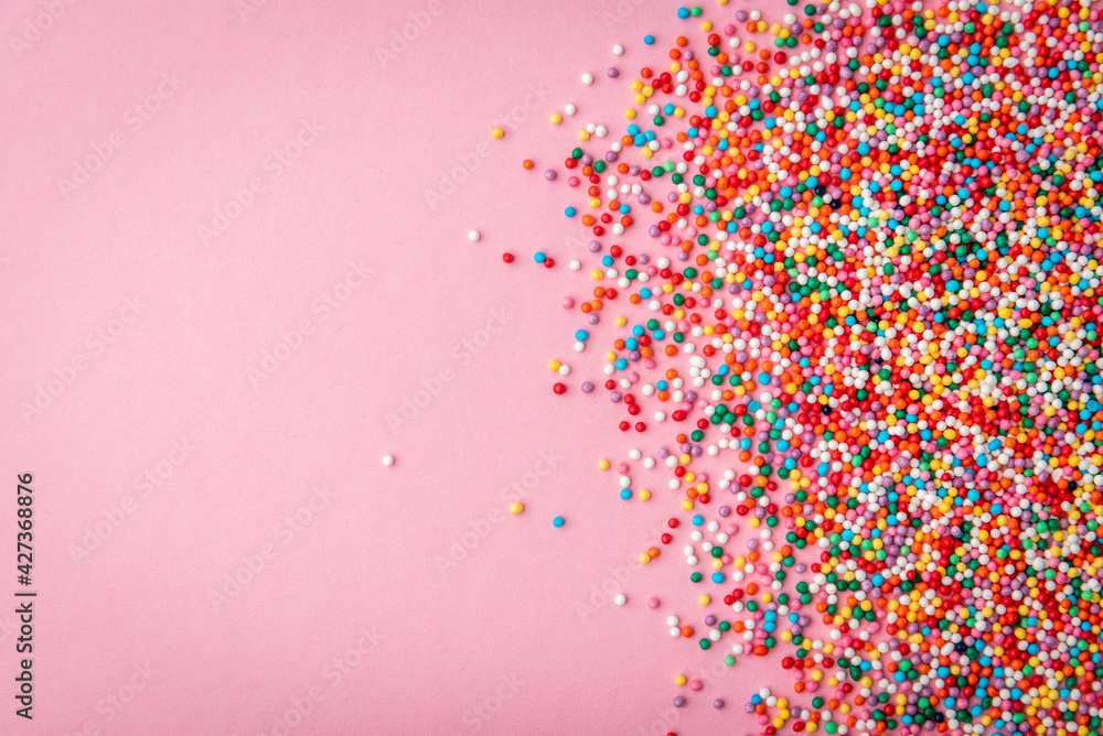 Colored sprinkles on pink background. Stock Photo | Adobe Stock
