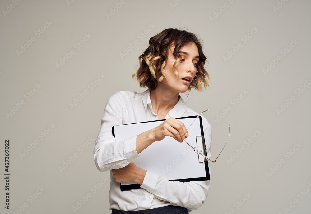 Business woman with a folder of documents in her hands on a gray background Copy Space Business woman with a folder of documents in her hands on a gray background Copy Space