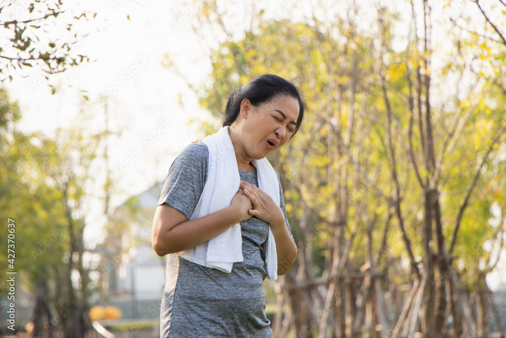 Old Asian people suffer from exercise pain. Senior woman having heart attack Old Asian people suffer from exercise pain. Senior woman having heart attack