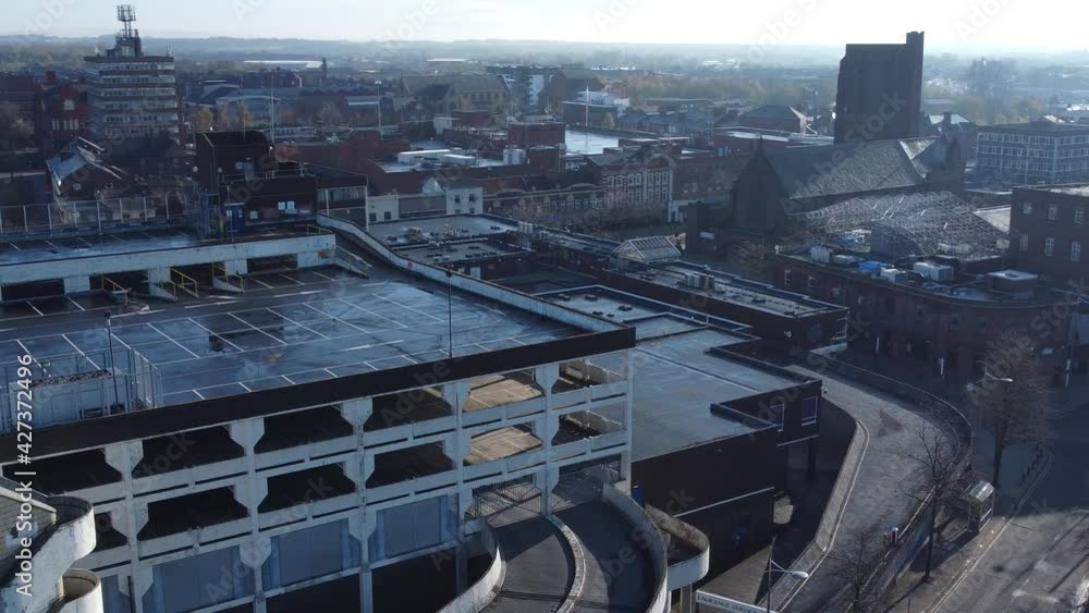 Overhead aerial view above city multi storey car park quiet British urban public streets at sunrise Overhead aerial view above city multi storey car park quiet British urban public streets at sunrise
