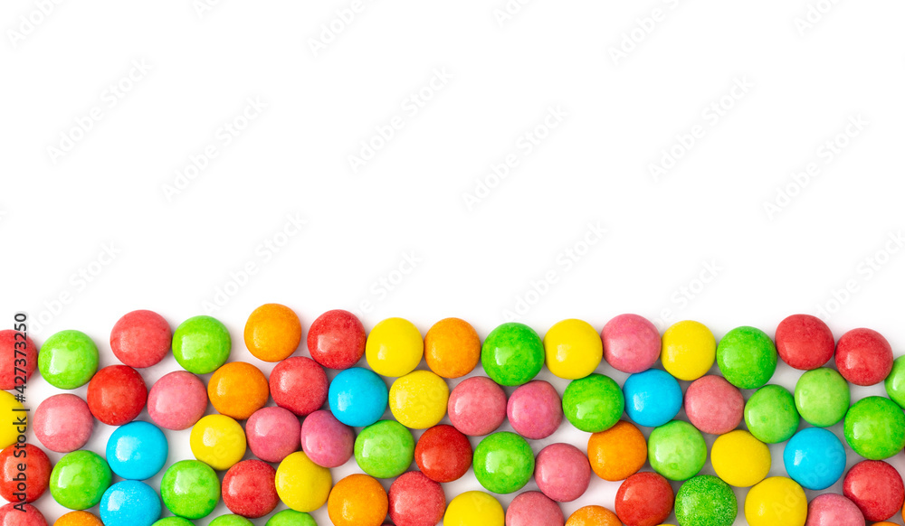 close up of colorful candies on white background with space for text. close up of colorful candies on white background with space for text.
