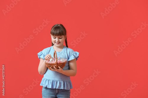 Cute little girl with baske...