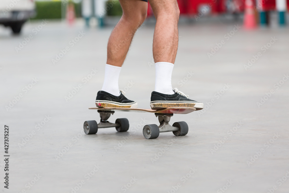 Obraz premium Young people playing skateboarding outdoor. Sports Concept