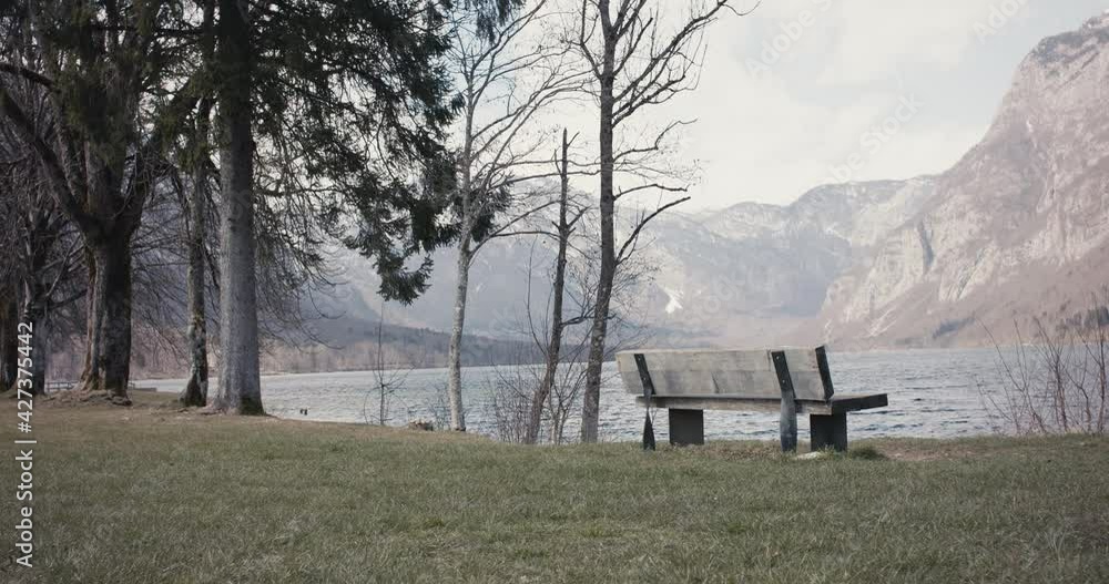 Empty bench by Alps lake tourist destination no people COVID lockdown Empty bench by Alps lake tourist destination no people COVID lockdown