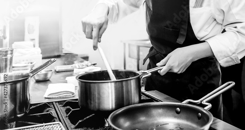 Chef cooking in a kitchen, chef at work, Black and White.