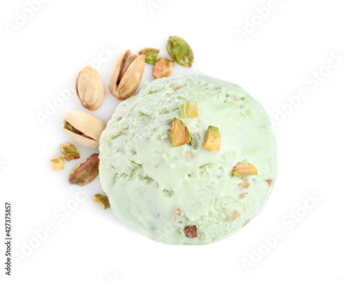 Scoop of delicious ice cream with pistachio nuts on white background, top view