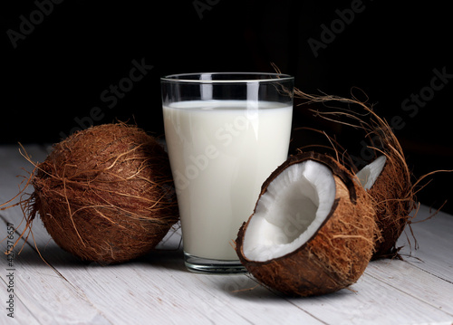 Coconut milk and chopped coconut in the black-and-white background.