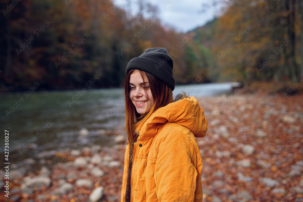 woman in a yellow jacket in the autumn forest fallen leaves river woman in a yellow jacket in the autumn forest fallen leaves river