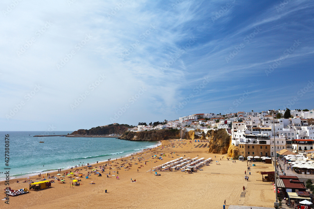 Portugal, Algarve. View from the observation deck on the old town of Albufeira and beautiful sandy city beach at sunny summer day, seaside vacation and travel
