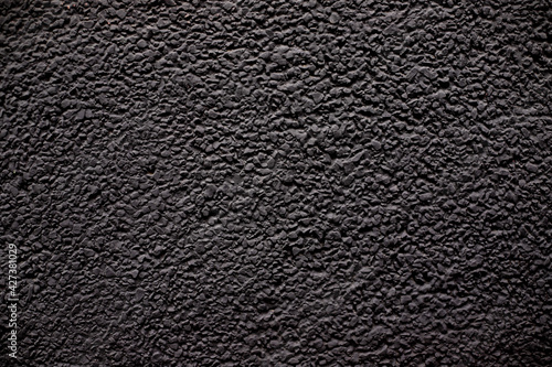 Concrete black wall background on the street.