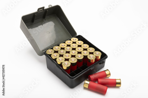 12-gauge shotgun bullet shells and plastic box on white background