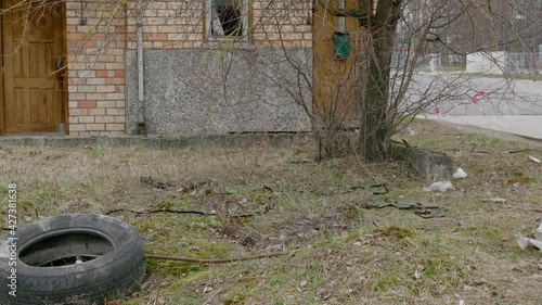 An old building made of kerpich, all polluted with garbage, plastic bottles, the concept of littering of nature photo