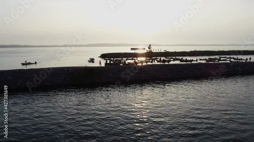people watching the start of bass tournament from jetty slow motion