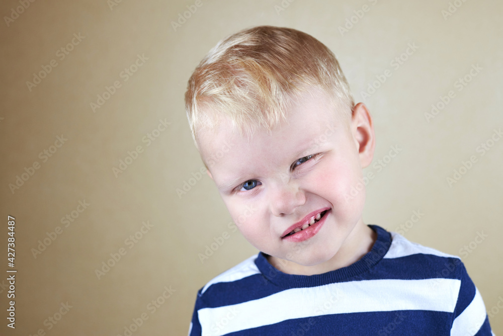 Naklejka premium Portrait of a three-year-old caucasian boy with a closed eye.