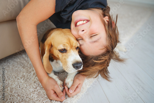 Little boy with a dog at home. Friendship, care, happiness, new concept of the year. High quality photo.