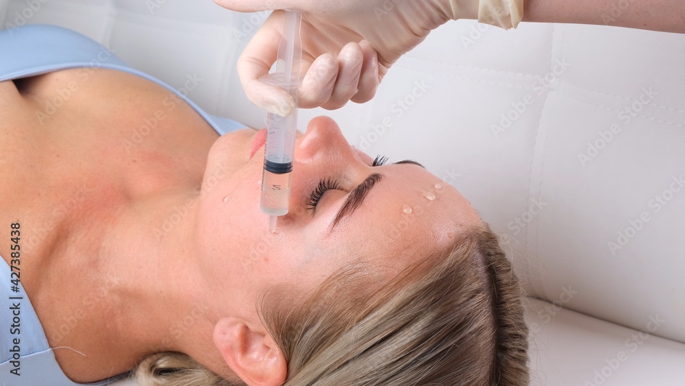Beautiful girl has a facial massage in a beauty clinic. Facial skin care concept . Beautiful girl has a facial massage in a beauty clinic. Facial skin care concept .
