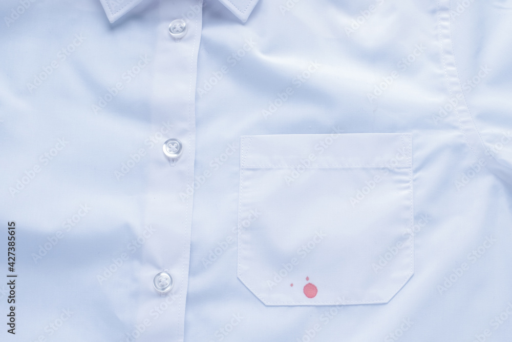 blood stain on clothes. isolated on blue background. top view blood stain on clothes. isolated on blue background. top view