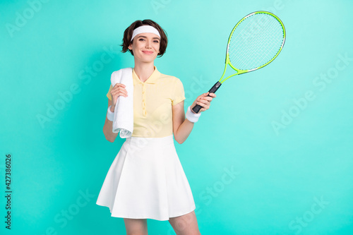 Photo of happy cheerful good mood lovely girl tennis player relaxing after training isolated on turquoise color background © deagreez