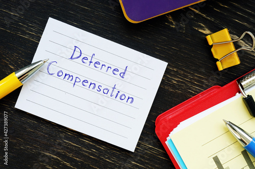  Financial concept about Deferred Compensation with phrase on the piece of paper. photo