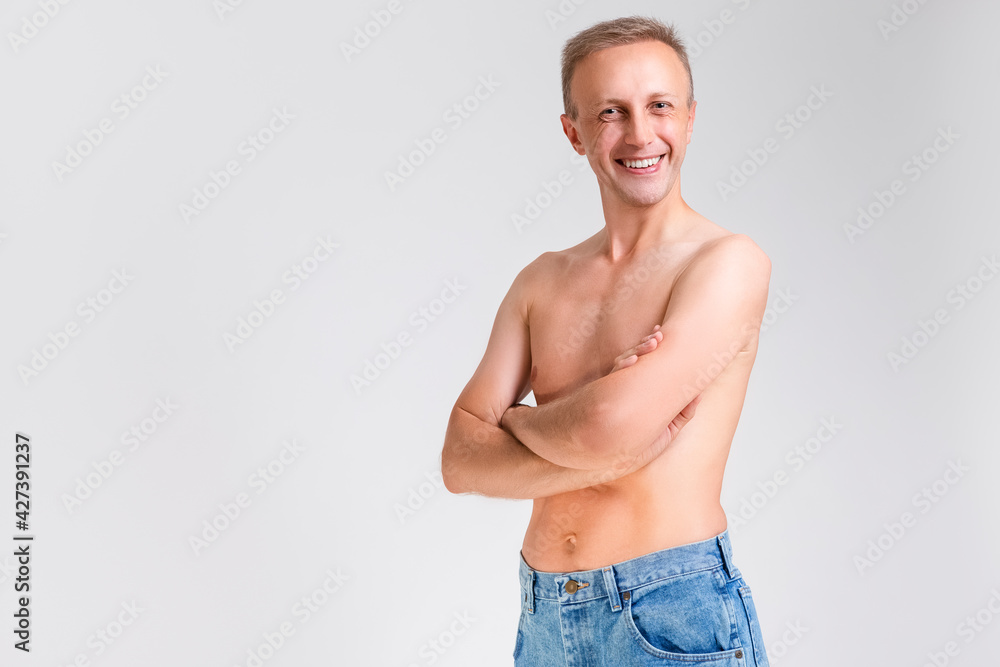 Natural Portarit of Smiling Caucasian Handsome Man Posing With Naked Torso On White Background. Natural Portarit of Smiling Caucasian Handsome Man Posing With Naked Torso On White Background.