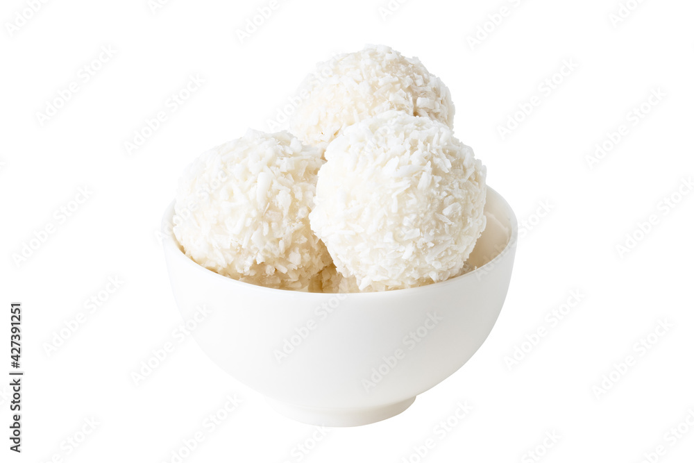 coconut candies in white cup isolated on white background coconut candies in white cup isolated on white background