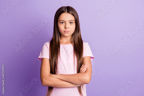 Photo of young serious preteen girl confident crossed hands concentrated focused isolated over violet color background