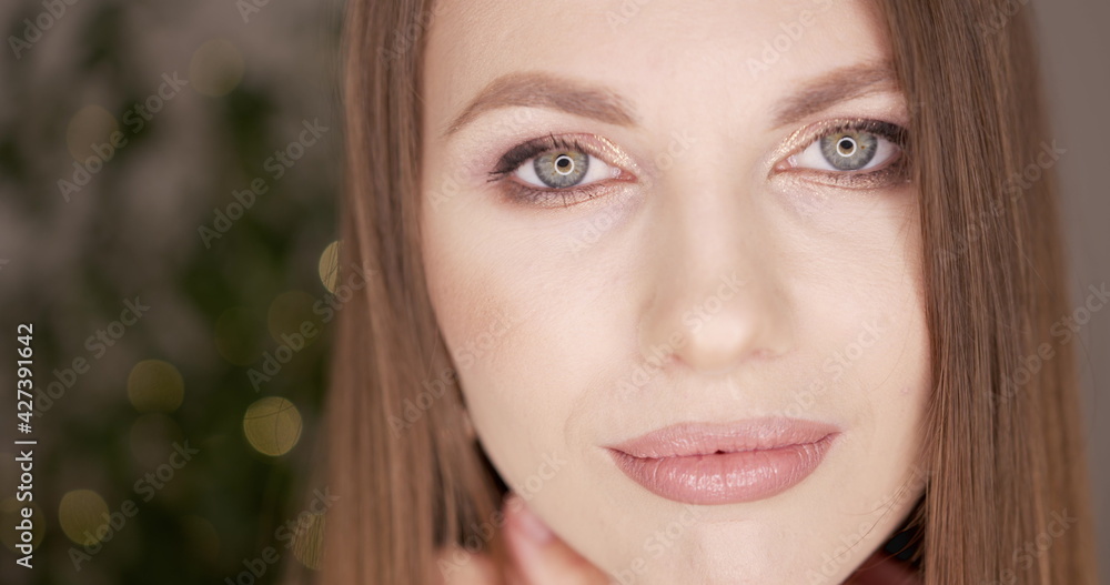 Beauty woman face with green eyes looking at camera. Skin care treatment or cosmetic ads concept. Beautiful female model with perfect fresh and clean skin. Nude make-up. In studio. Beauty woman face with green eyes looking at camera. Skin care treatment or cosmetic ads concept. Beautiful female model with perfect fresh and clean skin. Nude make-up. In studio.