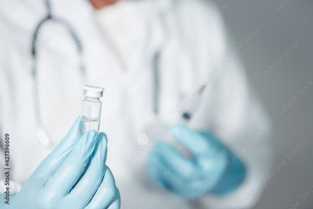 A doctor or scientist in a laboratory develops a medical vaccine. Holds a syringe with liquid vaccines to study and analyze antibody samples for new strain of COVID-19 patients in 2021.
A doctor or scientist in a laboratory develops a medical vaccine. Holds a syringe with liquid vaccines to study and analyze antibody samples for new strain of COVID-19 patients in 2021.