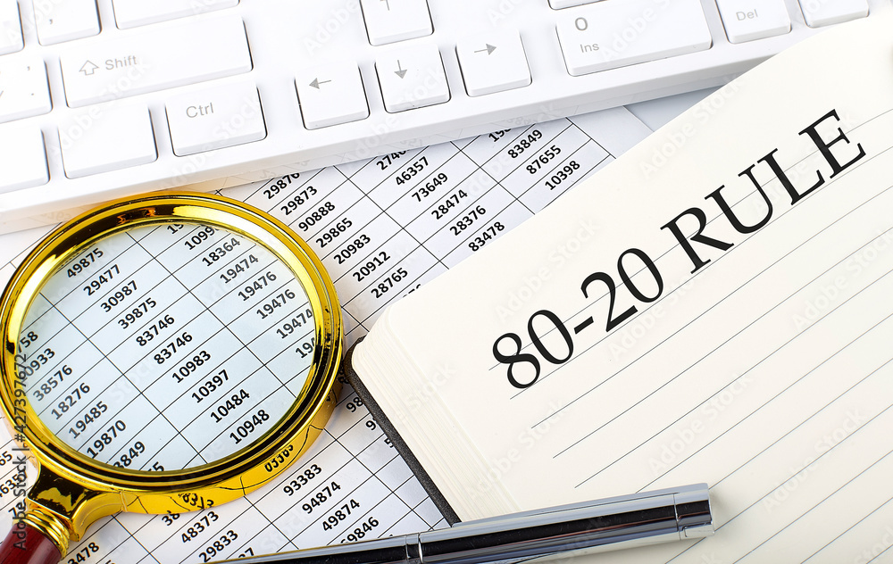 80-20 RULE text on notebook with chart, magnifier,keyboard and pen , finance and investment concept 80-20 RULE text on notebook with chart, magnifier,keyboard and pen , finance and investment concept