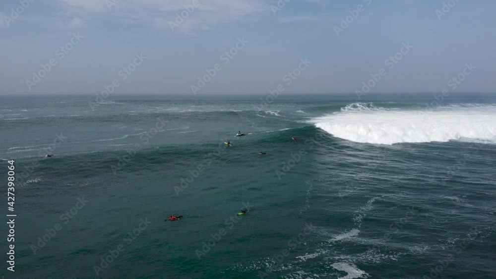 Aerial top-down drone view at surfers on waves, left to right move , 4k Aerial top-down drone view at surfers on waves, left to right move , 4k