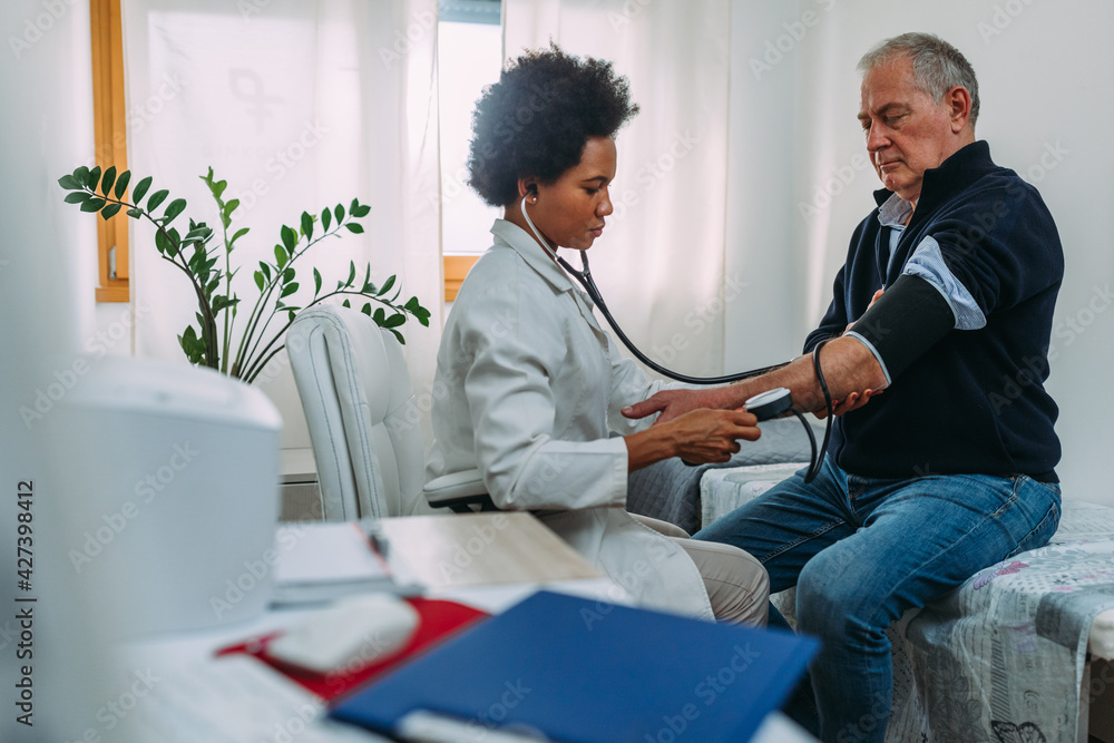 Doctor and patient during examination in office Doctor and patient during examination in office