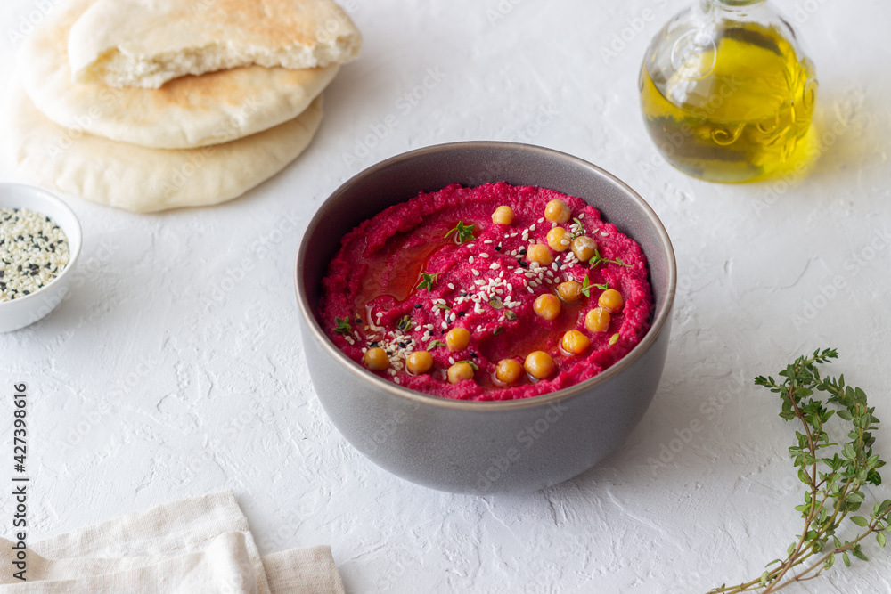 Beet hummus in a gray bowl. Healthy eating. Vegetarian food. Beet hummus in a gray bowl. Healthy eating. Vegetarian food.