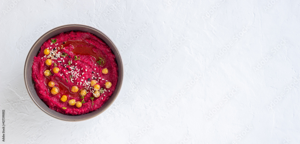 Beet hummus in a gray bowl. Healthy eating. Vegetarian food.