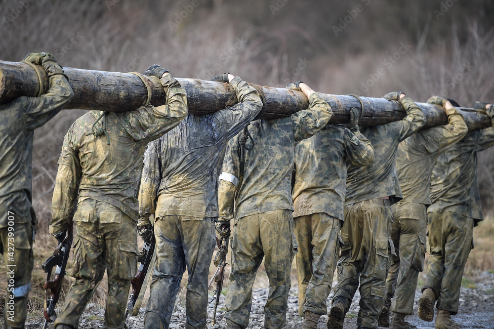 Special forces military training carrying a big log. Photograph detail