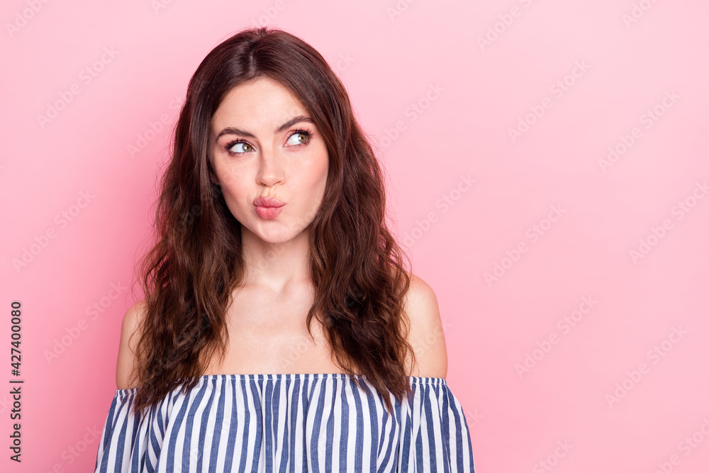 Photo of nice unsure brunette lady look empty space wear blue t-shirt isolated on pastel pink color background Photo of nice unsure brunette lady look empty space wear blue t-shirt isolated on pastel pink color background