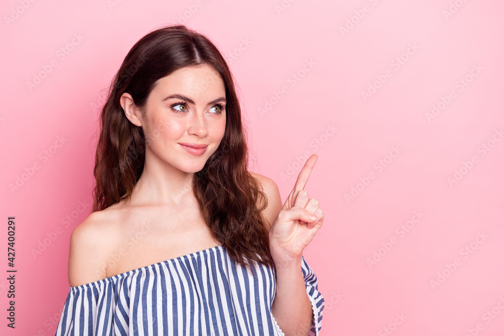 Photo of nice optimistic brunette lady point empty space wear blue dress isolated on pastel pink color background Photo of nice optimistic brunette lady point empty space wear blue dress isolated on pastel pink color background