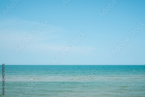 Seascape with sea horizon and almost clear deep blue sky on a sunny day