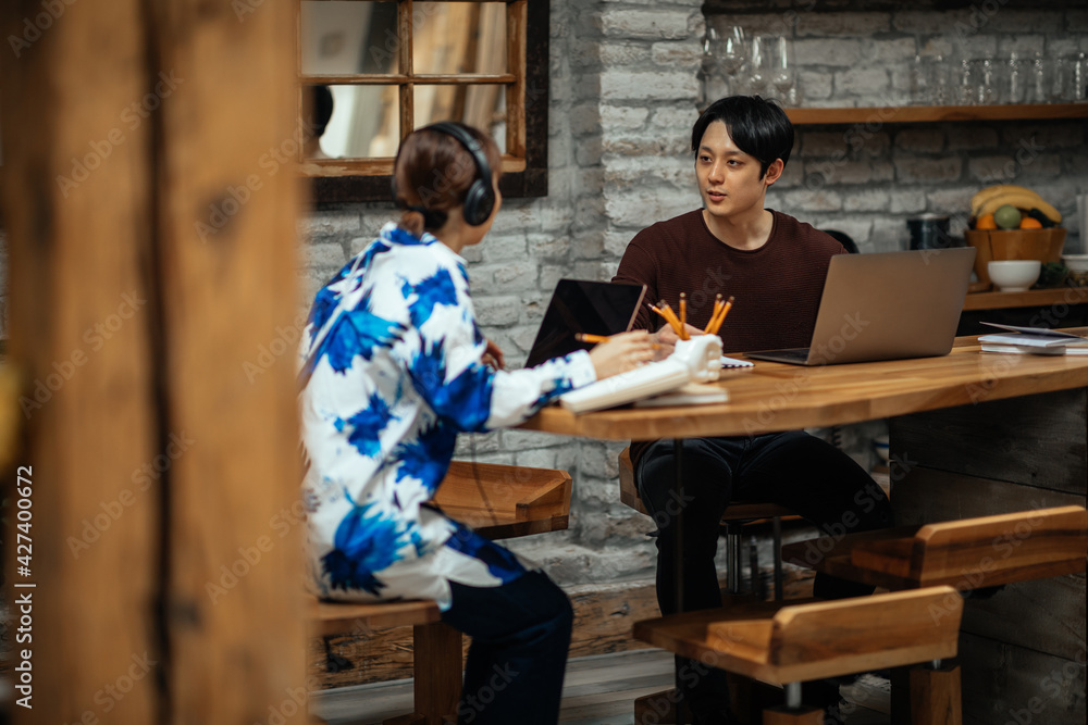 Japanese couple working at home via technology Japanese couple working at home via technology